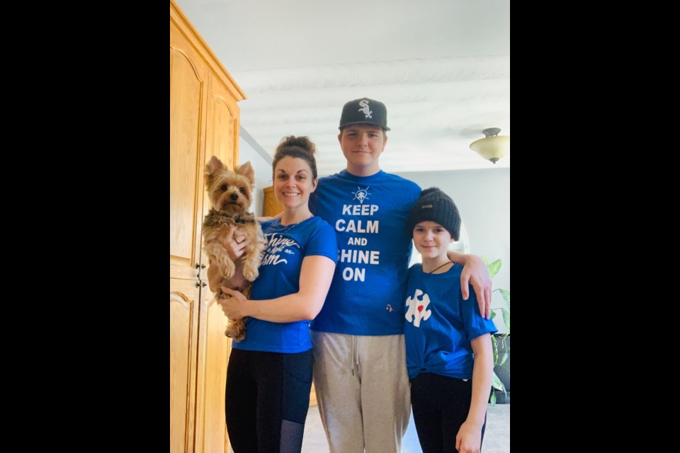 Céleste Séguin and her two children (Joshua Gobeil who has autism and Naomi Gobeil) celebrating Autism Awareness Day. Of course Jasper, their dog wanted in on the action!