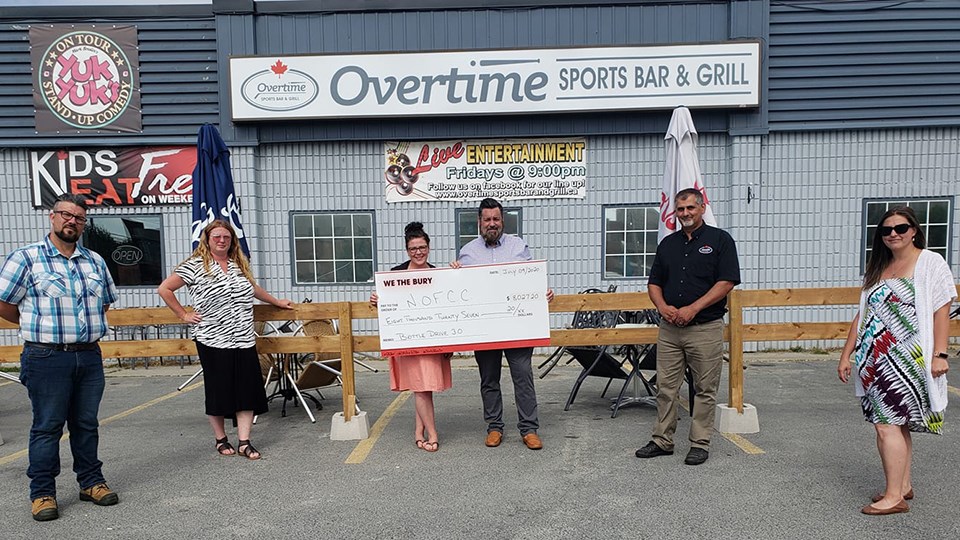 Pictured from left to right: We the Bury team member Riley Mignacca, Jana Schilkie of Jana Hospitality Consulting, We the Bury team members Ashlie Wainman and Curtis Loiselle, Overtime Sports Bar and Grill representative Attilio Langella and Dayna Caruso of Northern Ontario Families of Children with Cancer. (Supplied)