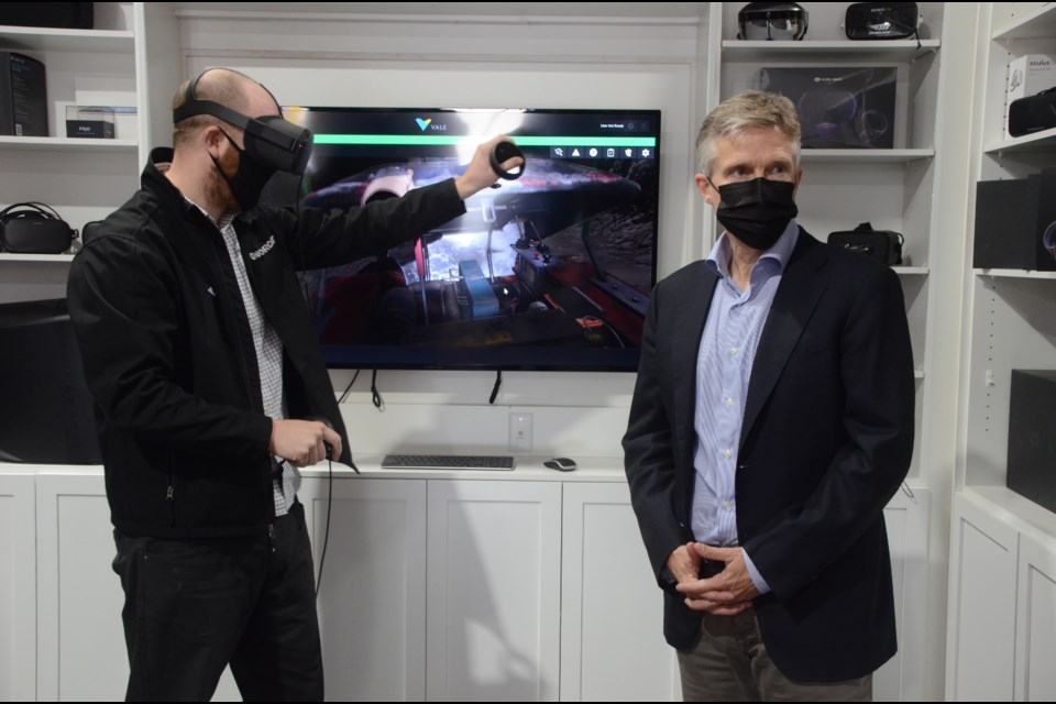 Finance Minister Rod Phillips gets a demonstration of virtual reality technology from NORCAT’s studio manager, Andrew Kostuik, during a tour on Friday. (Arron Pickard/Sudbury.com)