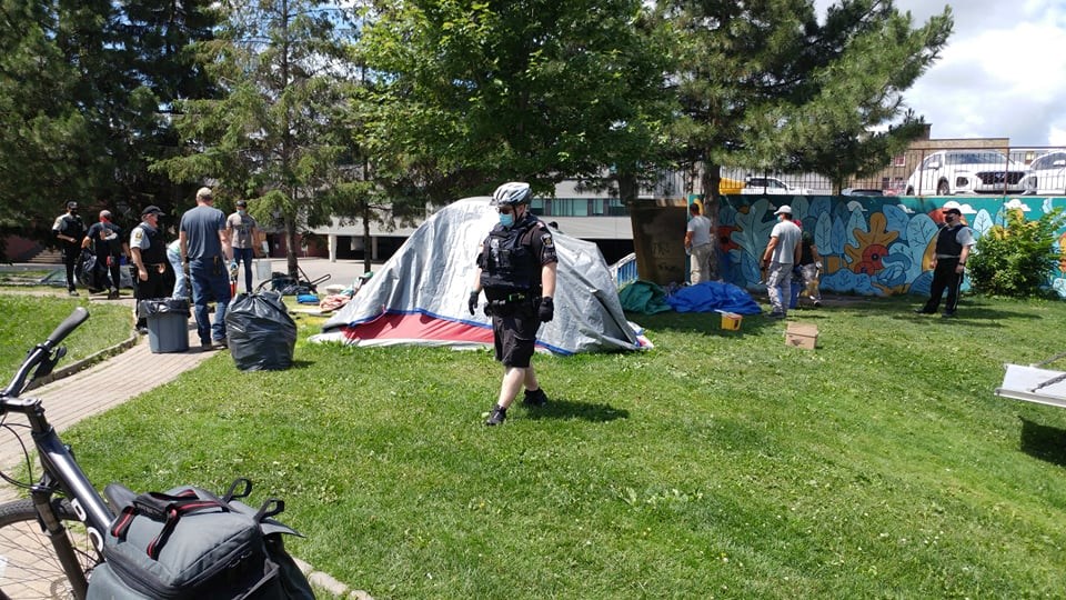 City bylaw officers dismantle the encampment in Memorial Park on June 30. 