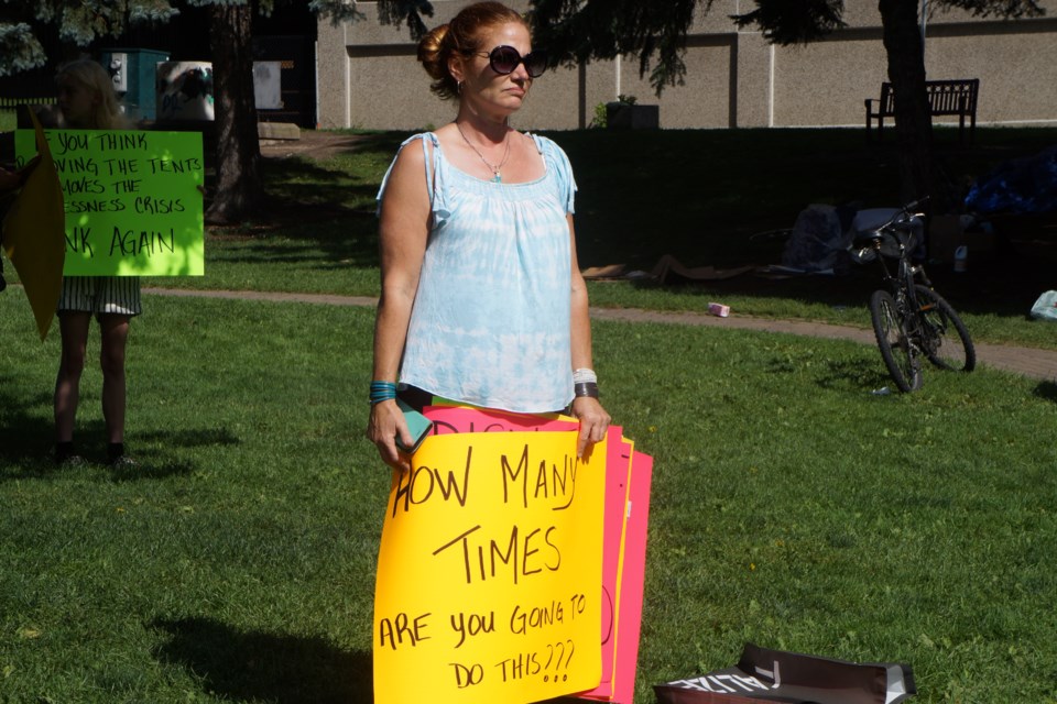 Melanie Johncox protests the dismantling of the encampment at memorial park, August 12. Her sign reads: "How many times are you going to do this?"                           