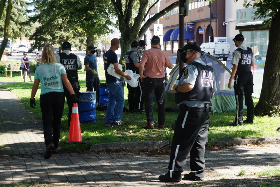 Bylaw officers and Parks employees in Memorial Park during the Aug. 12 dismantling. 
