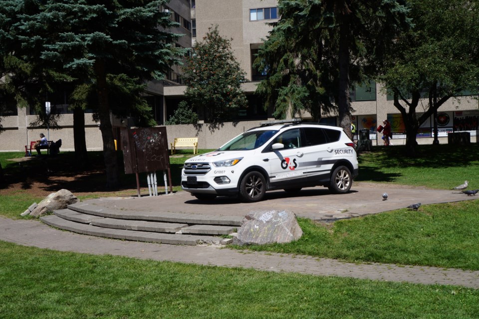 A security vehicle sits where the Memorial Park pavilion used to be.   The pavilion was in place during the dismantling of the encampment on Aug. 12 but was removed from the park on Aug. 13