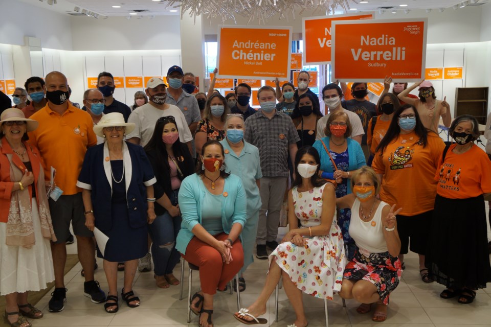 Volunteers and attendees pose for a photo with candidates Chénier and Verrelli up front. The group came together to launch the NDP campaign office on Sunday Aug. 22
                               
