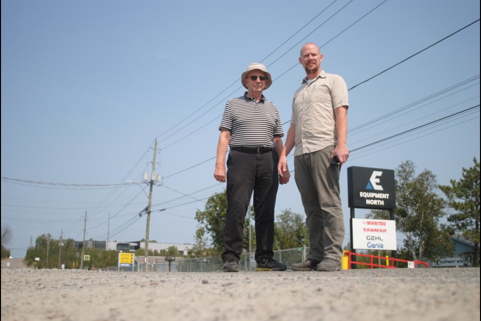 Peter and Ryan Matusch, the father-son duo behind businesses along Fielding Road, are seen standing on the road’s stretch of pavement earlier this week. The road has a pavement condition index of 34, which is classified as “poor.”