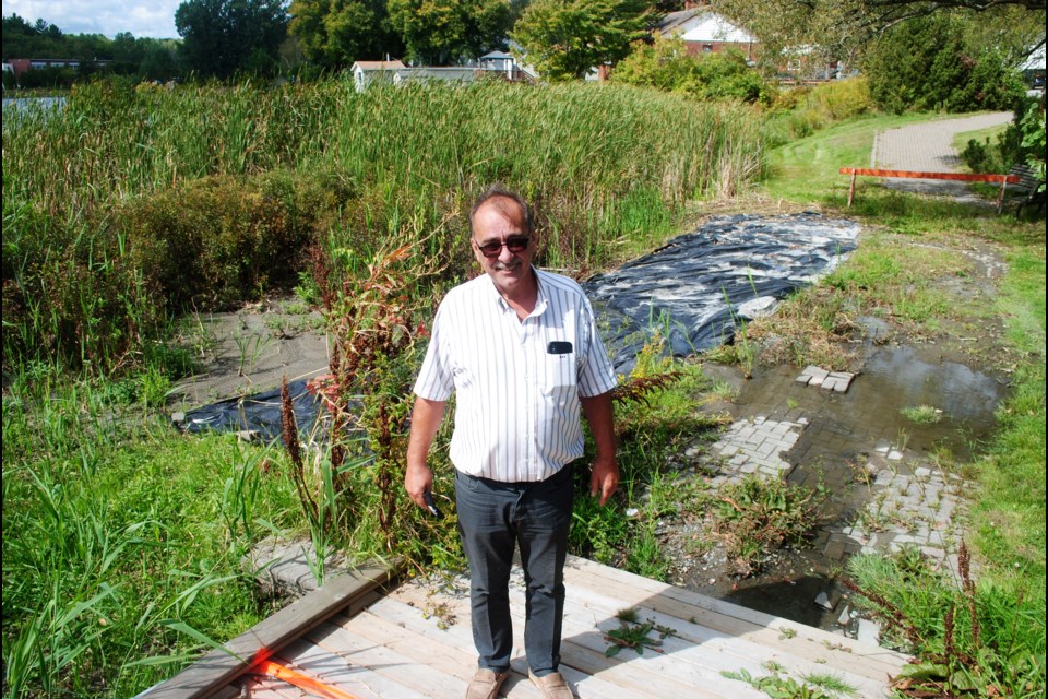                     Ward 11 Coun. Bill Leduc stands at a particularly dilapidated section of the Minnow Lake boardwalk, which runs parallel to Bancroft Drive.                 