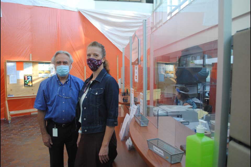 City of Greater Sudbury building services director and chief building official Guido Mazza and permits and approvals integration manager Denise Clement are seen next to the City of Greater Sudbury’s buildings department inquiries kiosk set up at the main floor of Tom Davies Square. 