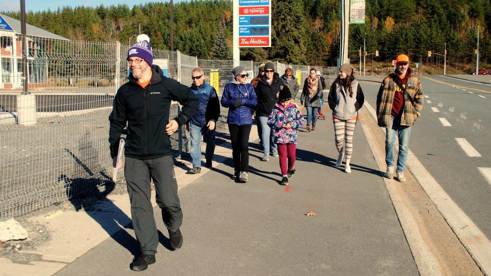 Coniston Historical Group president Jason Marcon leads a group of approximately a dozen people through Coniston during the inaugural Walk For Wenjack on Saturday. 