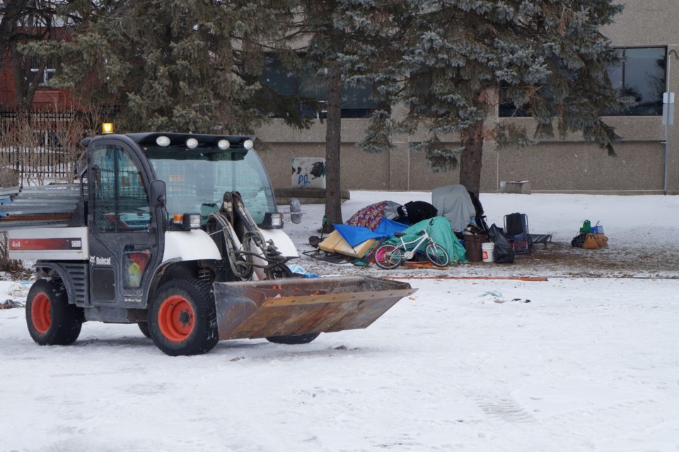 The Memorial Park encampment is seen being dismantled on Friday.
