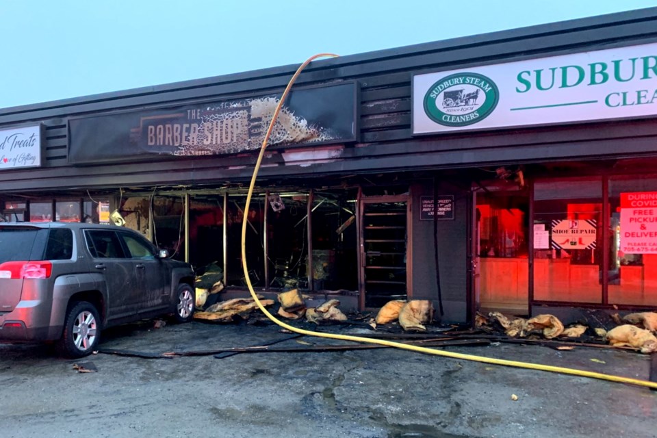 Firefighters battle a blaze at a barber shop located in a plaza at 1769 Regent Street in the early morning hours of March 16. The fire is being treated as suspicious. (Twitter.com/JesseOshell)