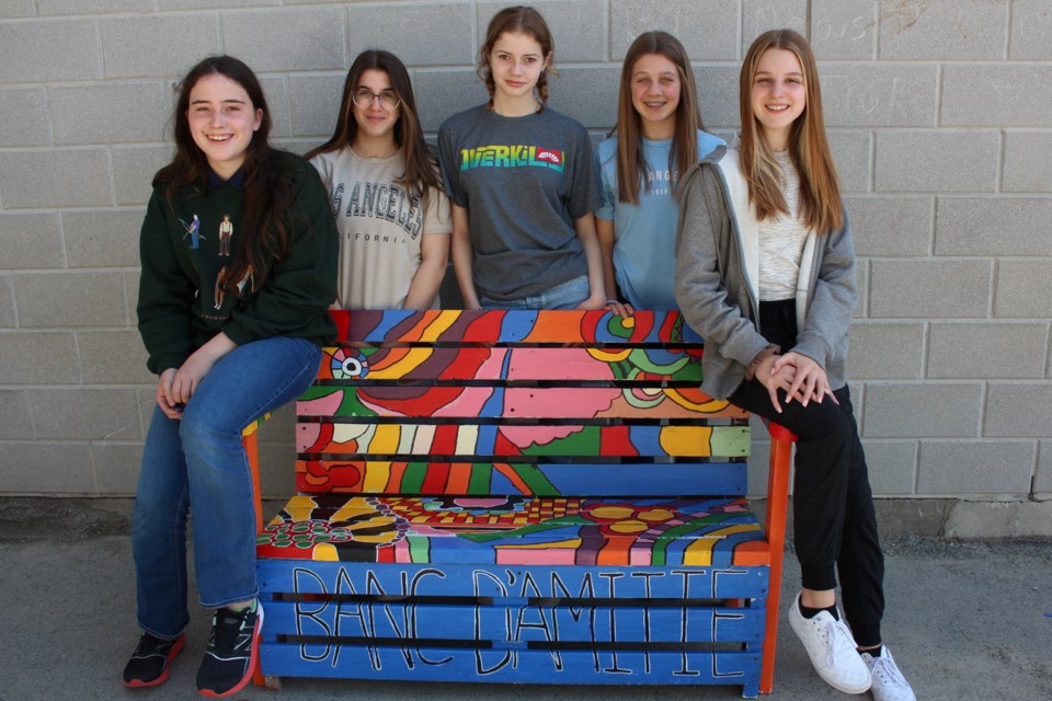 From left are École St-Denis students Arielle Hutchings, Chiana Rocca, Amélia Lefebvre, Sophie Miller and Anella Zembrzycki with one of the school’s buddy benches