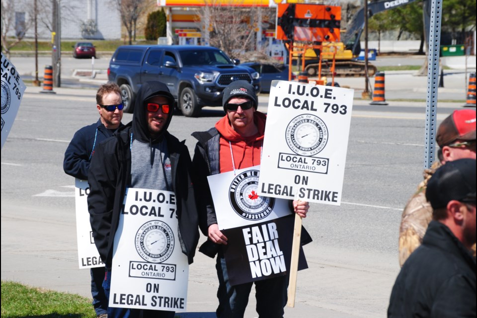 International Union of Operating Engineers Local 793 members are seen picketing on The Kingsway earlier today. They have been on strike since Monday.