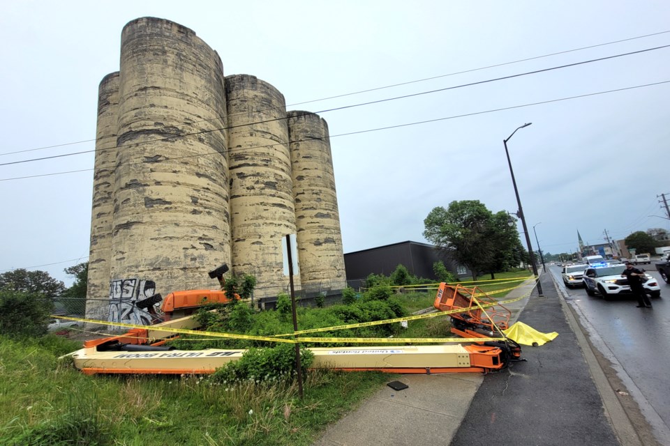 A cherry picker is seen toppled over at the historic Flour Mill silos site on Paris Street following a workplace incident on June 