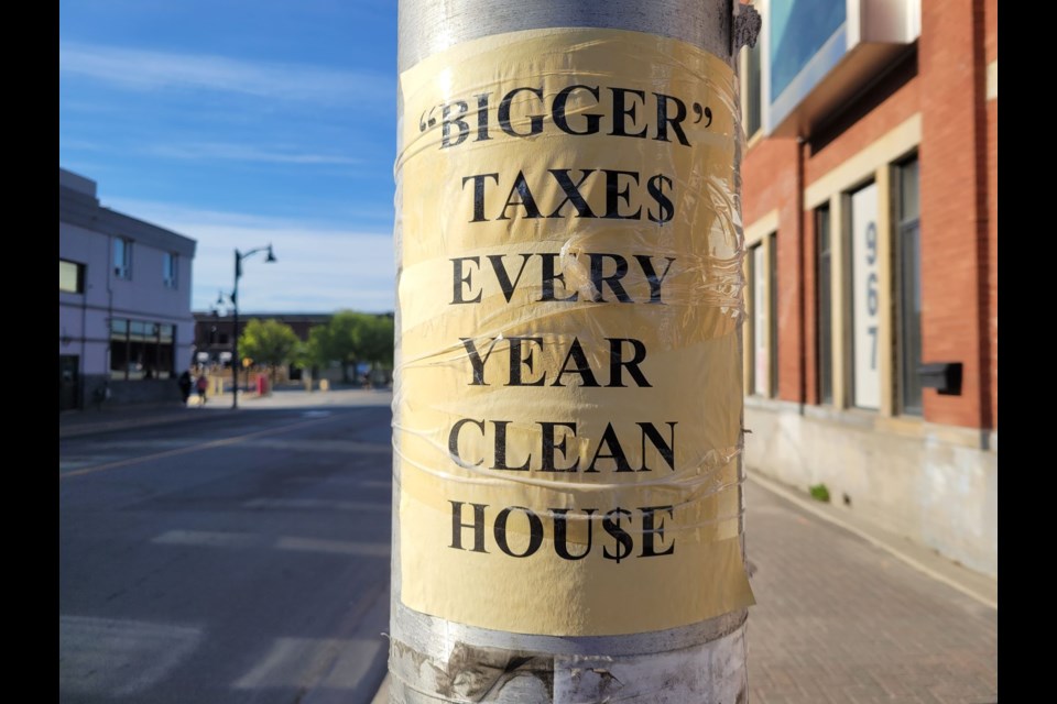 One of several signs is seen taped to a pole in downtown Sudbury earlier this week, which targeted Mayor Brian Bigger and the current city council.