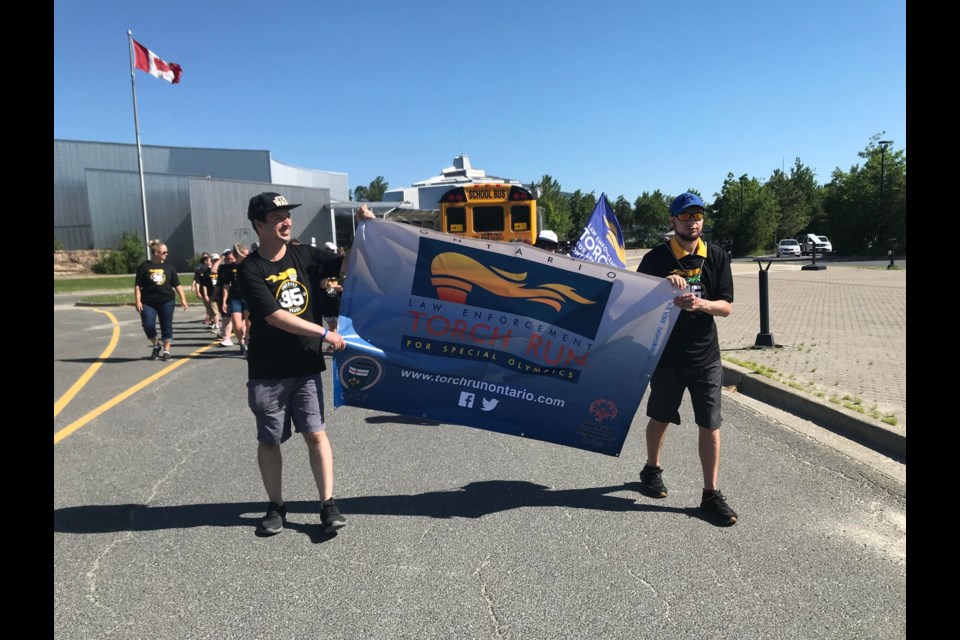 Participants in the 35th annual Law Enforcement Torch Run in support of Special Olympics start out on their walk from Science North Wednesday morning. 