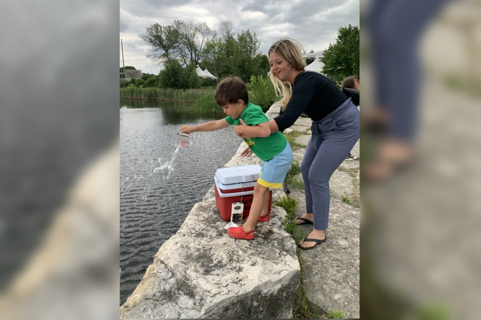 Algonquin Road Public School Kindergarten student Dawkins Tremblay and his mother Courtney Tremblay released walleye fry from the school's hatchery into Ramsey Lake on June 28.