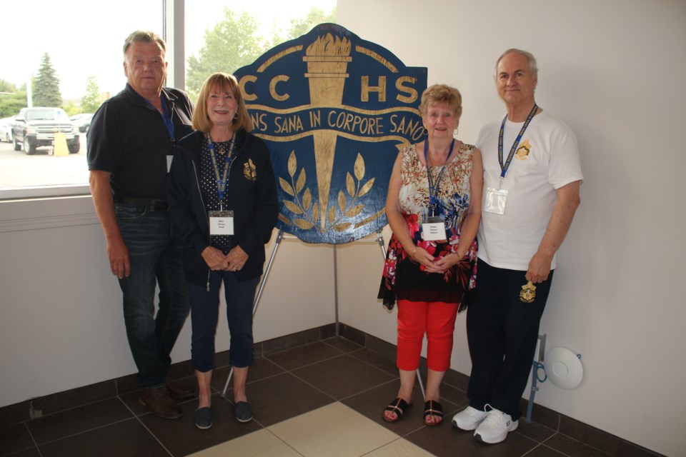 From left are Brian Bertulli, Rita Friel, Diane Herbert and Al Nesseth posing with the Copper Cliff High School logo.