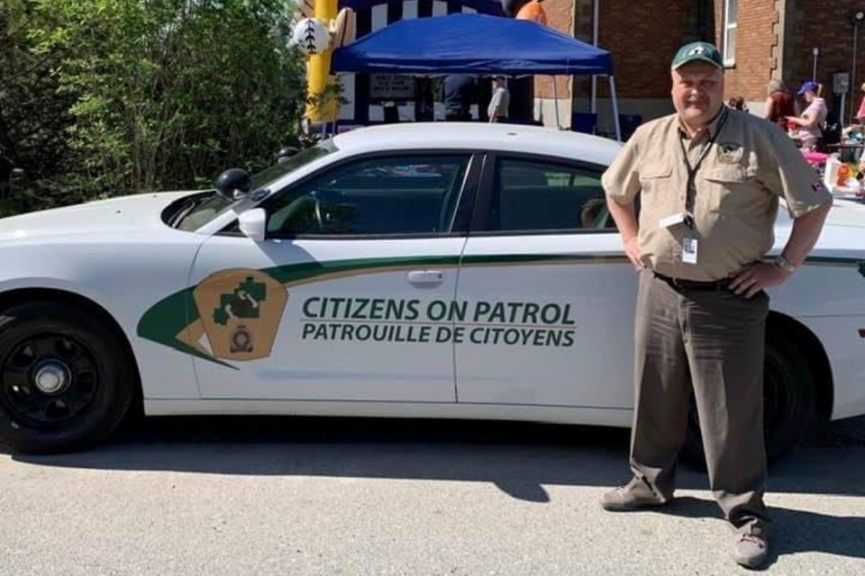 Copper Cliff Citizens on Patrol captain Theo Reed is seen in his uniform next to one of the vehicles the Greater Sudbury Police Service used to provide for volunteers. 