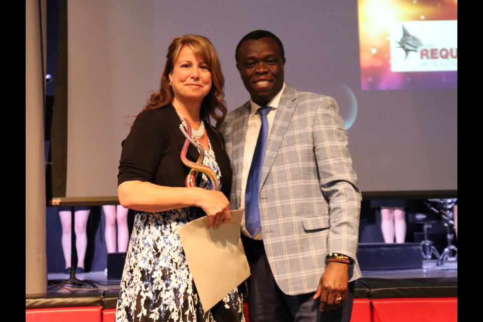 Sherry McAllister receives her award from superintendent of education Jhonel Morvan. (Supplied)