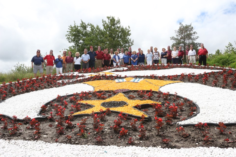 Sudbury Shrine Club members gather for a group photo at Bell Park to celebrate the opening of a garden they teamed with the City of Greater Sudbury to create in celebration of their 100th anniversary in the city. 

