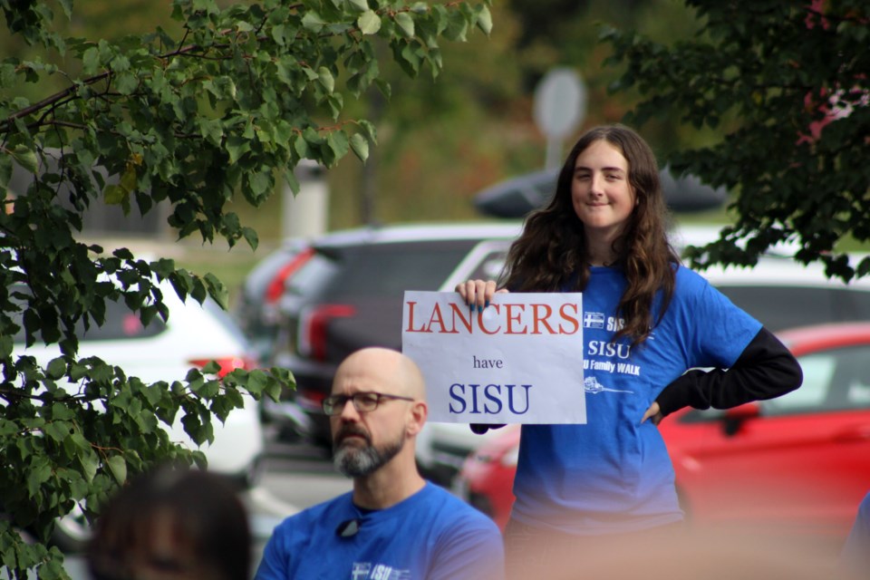 A crowd listens to keynote speakers outside of Lasalle Secondary School before walking to Finlandia on Saturday. 