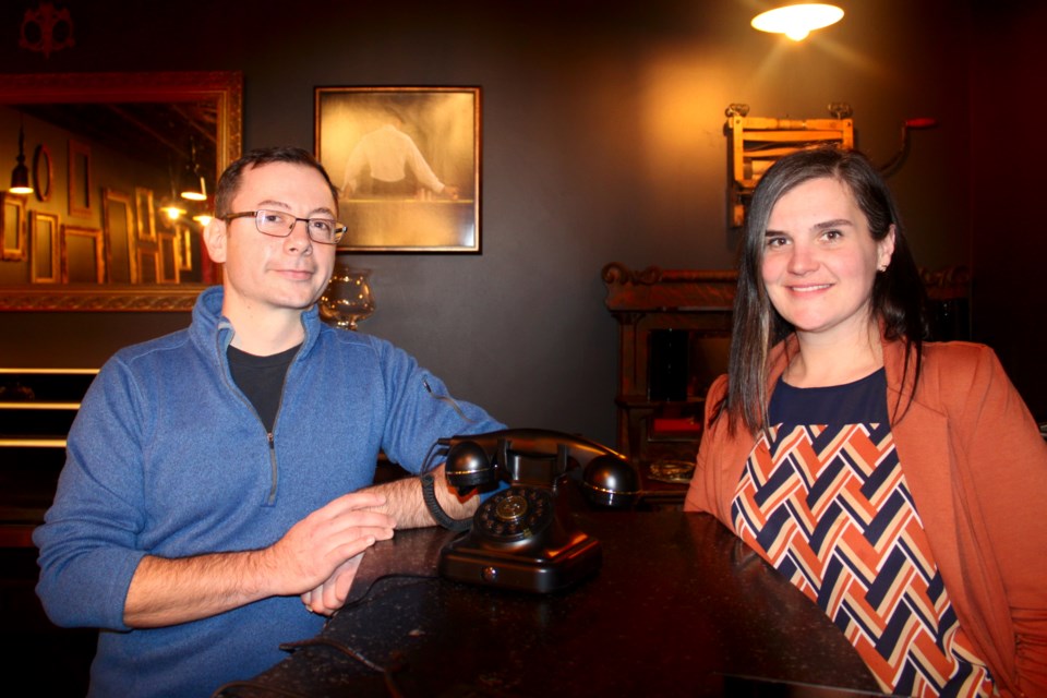 Centreline Architecture partner and building co-owner Dan Guillemette is seen with Books and Beans / The Night Owl owner Liana Bacon in a prohibition-era speakeasy-style bar in the basement of 158 Elgin Street. Between the two is a telephone visitors will call from a phone booth posted outside to gain entry.