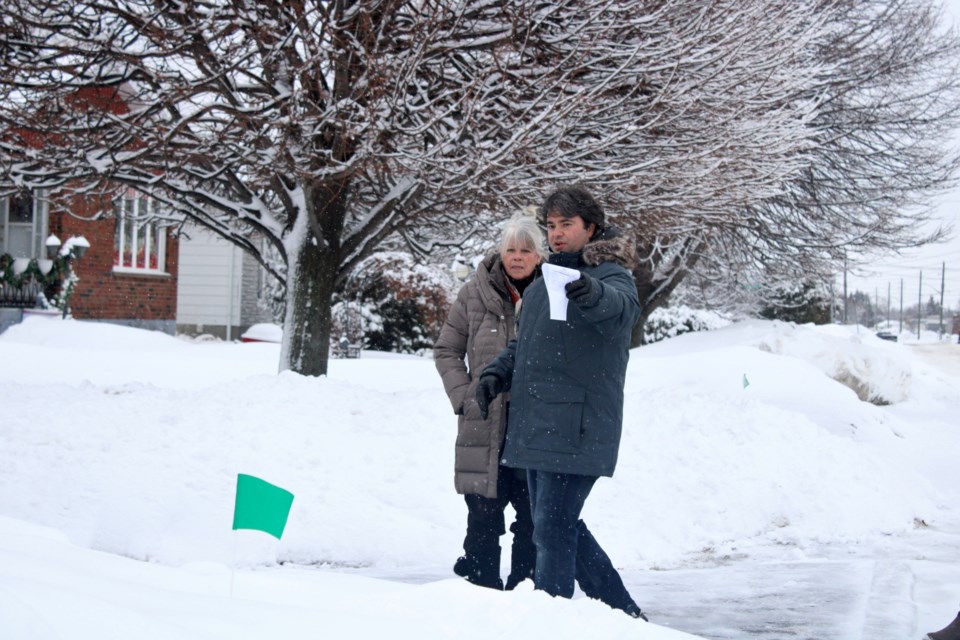 During a site tour on Friday, city traffic and asset management supervisor Joe Rocca points out to Ward 12 Coun. Joscelyne Landry-Altmann where a sidewalk could be installed on Sparks Street, pending city council approval.