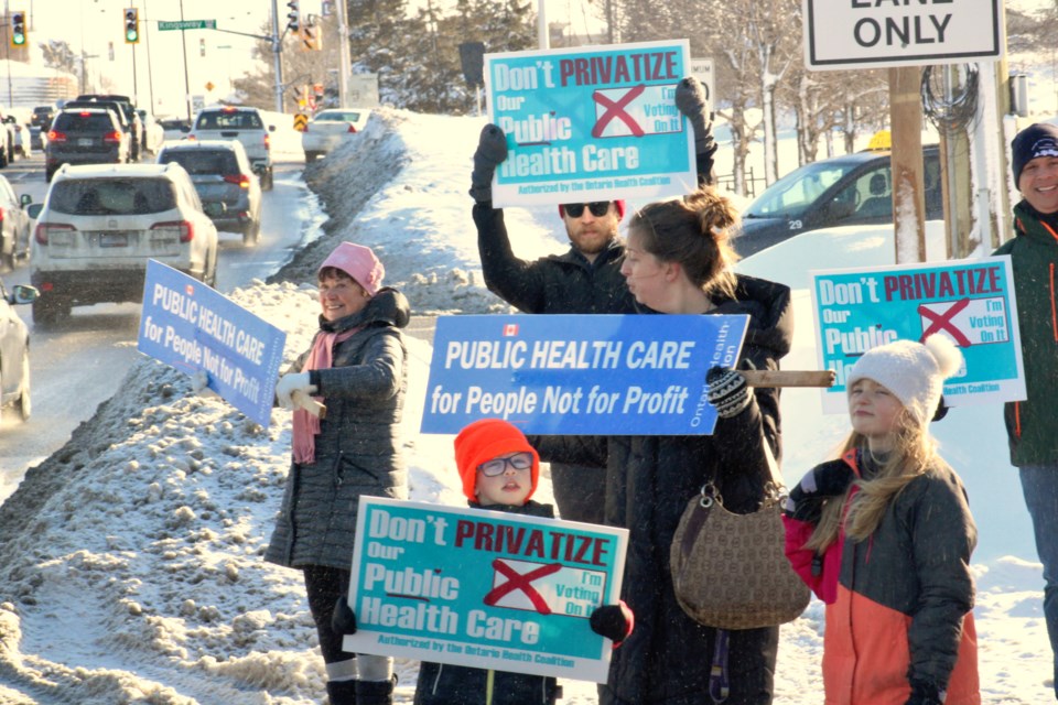 Protesters are seen along Barrydowne Road on Saturday, where they protested against health-care privatization.