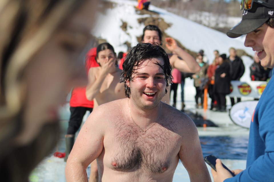 Jack Horsfall makes his way away from the water after taking part in Saturday’s polar plunge at Ramsey Lake. 
