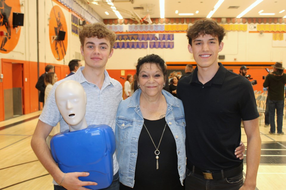 Lifesavers Levi Owl, left, and Tyler Brouillette, right, pose for a photo with Claudette Lecuyer, the woman whose life they’re credited with saving by administering CPR after they found her in a vehicle that went off the road as a result of her going into cardiac arrest.
