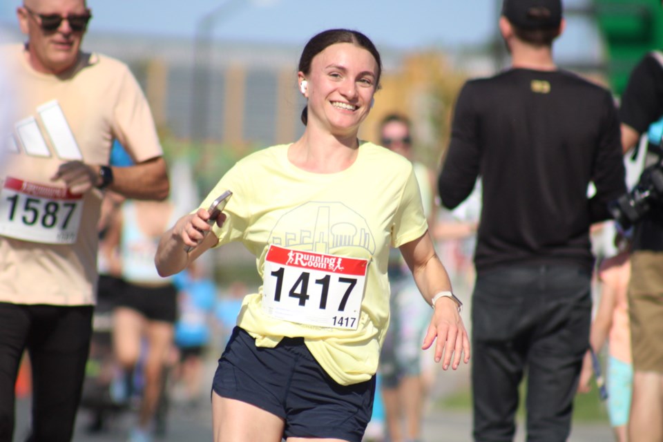 Sara Perfetto is all smiles as she nears the finish line of a five-kilometre race during the Sudbury Rocks Marathon in downtown Sudbury on Sunday. 