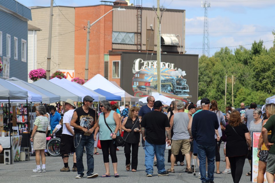 People walk through downtown Capreol during Capreol Days festivities on Saturday.