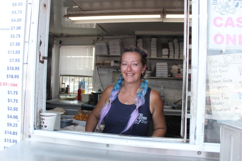 Silver Bullet owner Amanda Burton poses at her Silver Bullet 2.0 chipstand on Lasalle Boulevard Aug. 20, during the Rock the Bullet fundraiser.