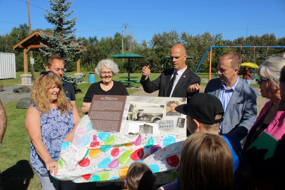 Family and dignitaries unveil a plaque in Percy Johns’ honour at Claude Charbonneau Park.