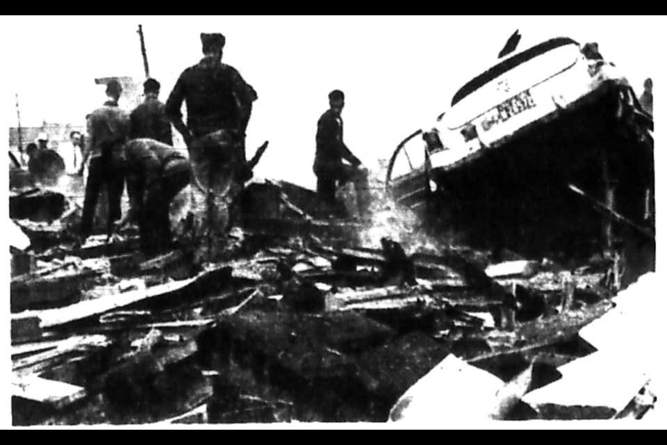 A burned out car can be seen in the rubble of the service station.