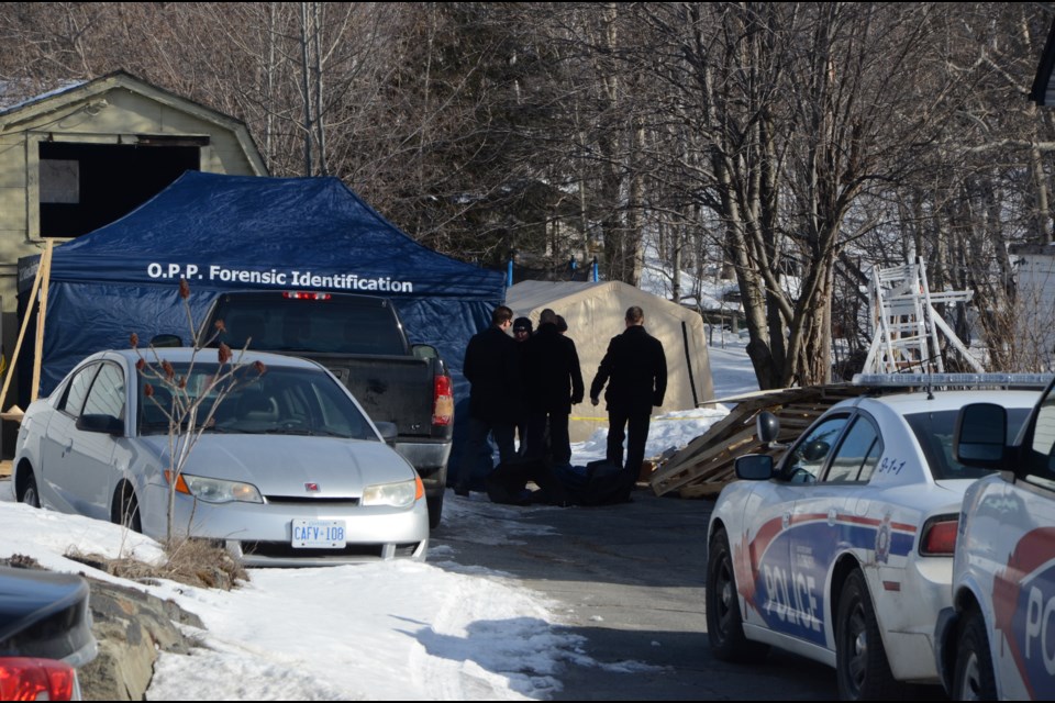 Investigators and members of the Forensic Unit are on location at 1690 Bancroft Drive, where a body was found following a shed fire on March 11. Photo by Arron Pickard.