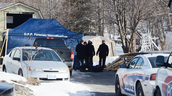 Investigators and members of the Forensic Unit on location at 1690 Bancroft Drive, where a body was found following a shed fire on March 11. Photo by Arron Pickard.