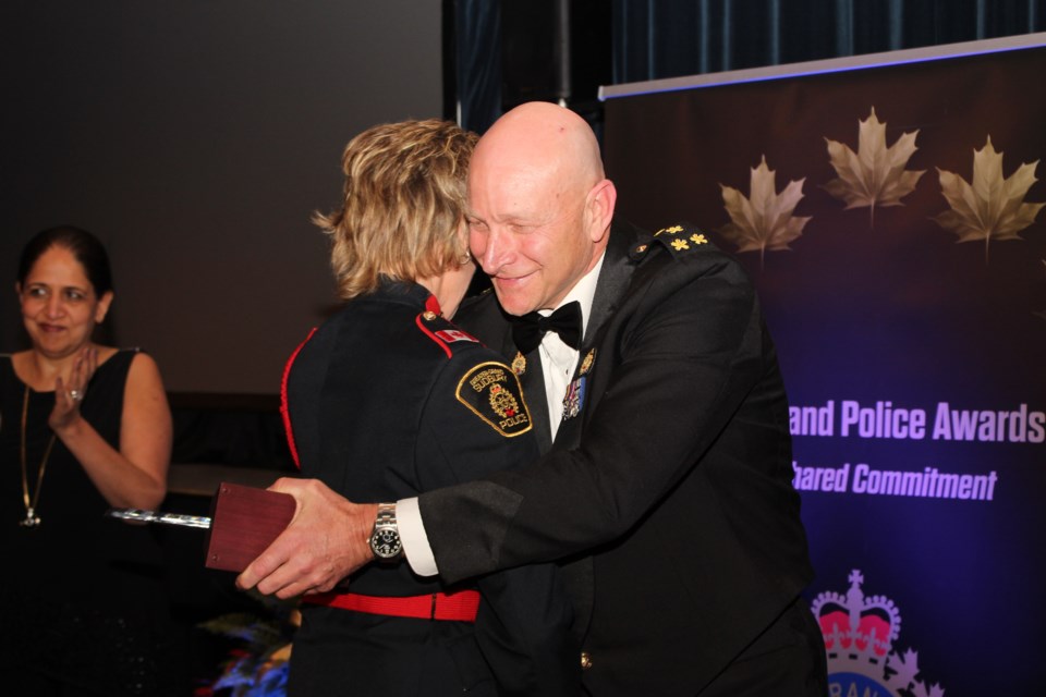 GSPS chief Paul Pedersen embraces Sgt. Joanne Pendrak, who received the Meritorious Action Award. (Photo: Matt Durnan)