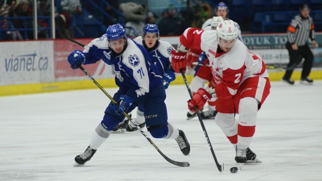 Sudbury Wolves David Levin battles for the puck in the first period against the Soo Greyhounds on Sunday afternoon. Photo by Arron Pickard.