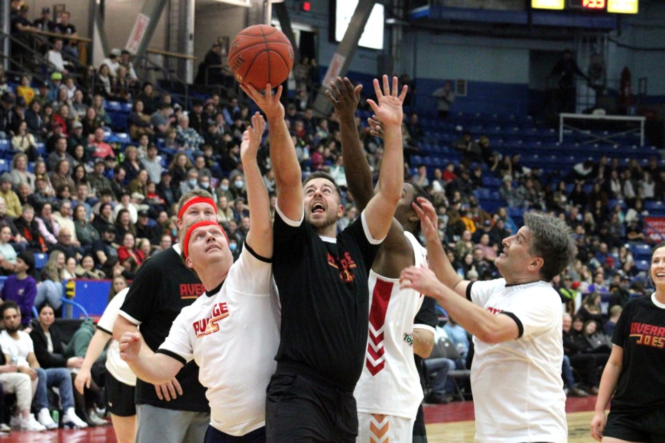 Players grapple for the ball during Thursday’s pros vs Joes charity basketball game at the Sudbury Community Arena. At centre is Nick Liard (news and midday host for Rock 92.7), left is Paul Lefebvre (mayor) and right is Dino Rocca (VP and market leader/wealth advisor at BMO Private Wealth). 
