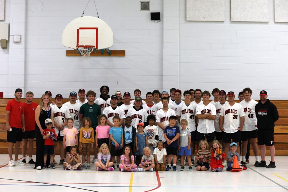 Thunder Bay Border Cats players  with Gron Morgan kindergarteners, encouraging active learning and community engagement.