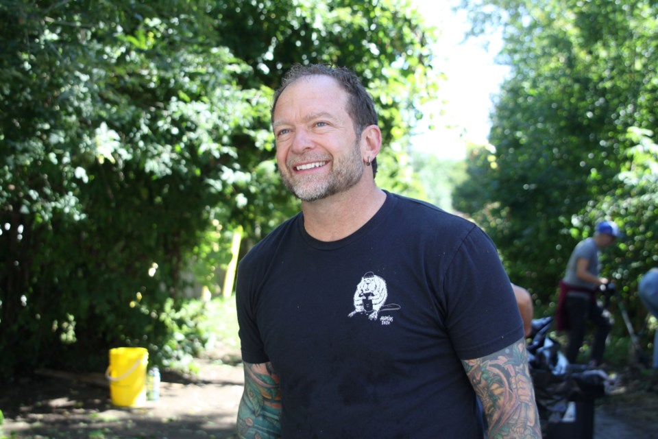 Counsellor Brian Hamilton, cleaning an alleyway off of May Street on Aug. 29, 2025.