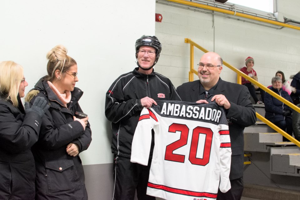 Jason Perrier presents Bill Nicholson with an honorary Hockey Canada Ambassador jersey- photo by Adam Sabaz