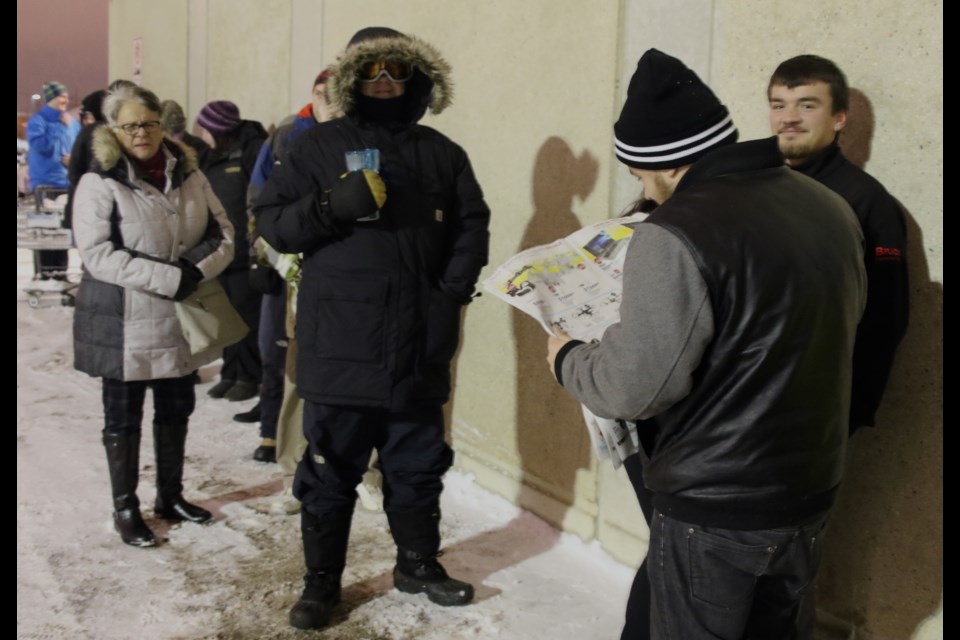 Devon and Austin Jaklitch (right) stand in a lineup of 70 eager Boxing Day shoppers outside of Best Buy at 5:30 a.m. Monday. 