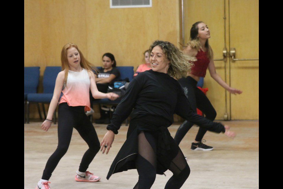Professional dancer, Angelica Migliazza, leads the senior class in some new dance moves during the Next Level Dance Workshop held Wednesday with fellow professional dancer, Emma Dubinsky. 