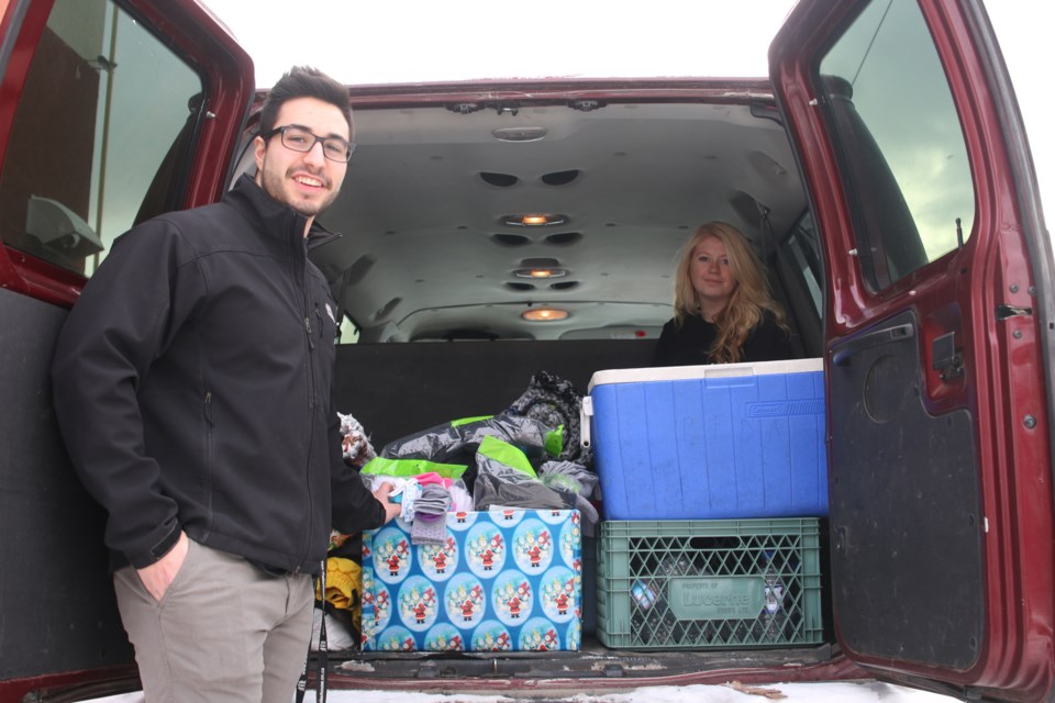 Adam Cupelli (left) and Jess Langile (right) prepare the SOS van for another night assisting people on the streets of Thunder Bay. 