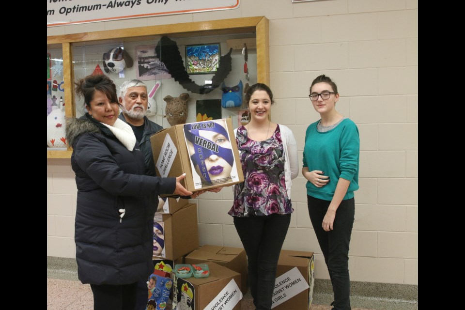 Jaime Adams (far right) and Calie Hill, present more than 280 toiletries and toys to Tammy Boyd of Beendigen Crisis Home at Westgate High School. 