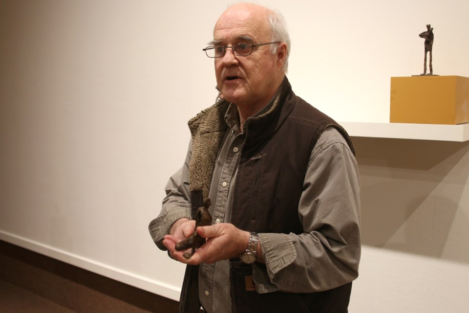 Sculptor John Books holds one of his bronze sculptures at his new exhibit, Oxen of the Sun. Books encourages viewers to touch and handle his sculptures at the Thunder Bay Art Gallery. (Photos by Doug Diaczuk - tbnewswatch.com). 
