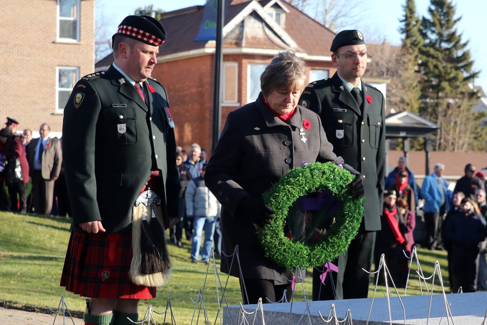 Silver Cross Mother Carol Klukie (centre) lays the first wreath on Friday; Nov. 11; 2016 at the Waverley Park cenotaph in Thunder Bay to mark Remembrance Day. Her son Josh Klukie was killed in Afghanistan (Leith Dunick; tbnewswatch.com).