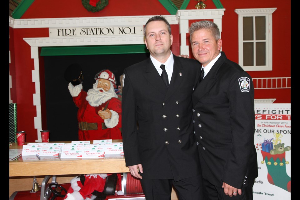 Toys for Tots chair Paul Penna (right) and co-chair Ryan Currie help kick-off this year's Toys for Tots campaign.